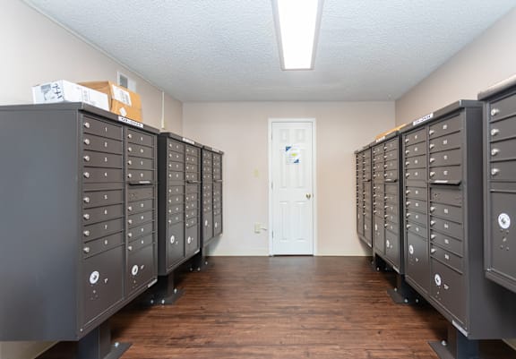A room with a white door and a row of filing cabinets.