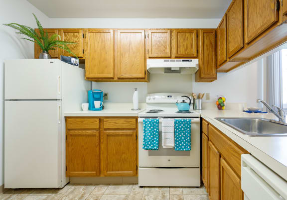 a kitchen with white appliances and wooden cabinets