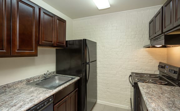 a kitchen with a sink and a refrigerator