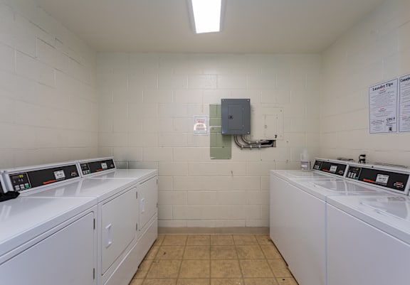 A laundry room with washers and dryers.
