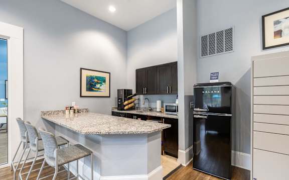 A kitchen with a granite countertop and a refrigerator.