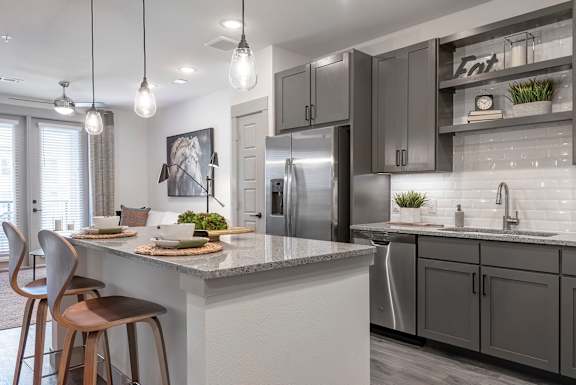 A modern kitchen with a dining table and chairs.