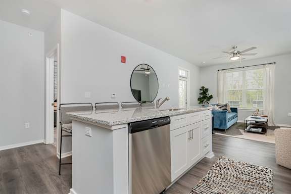 A modern kitchen with white cabinets and a large island.