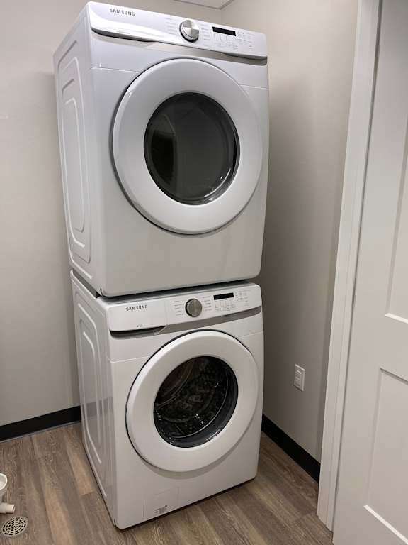 Two Samsung front loading washing machines stacked on top of each other.