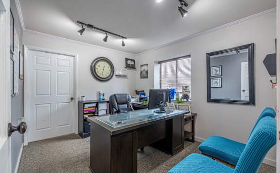 A room with a desk and a blue chair at Winchell Way Apartment , Kalamazoo, Michigan