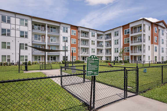 Apartment complex with a sign in front of it.