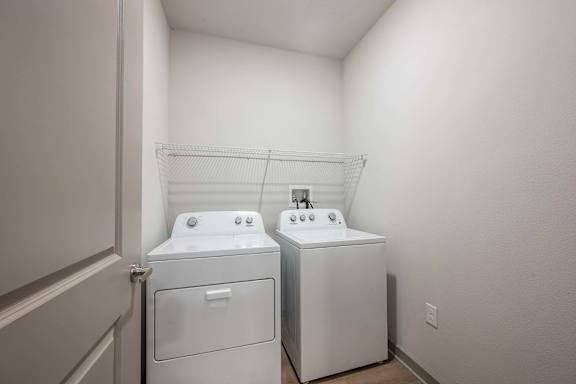 A laundry room with two washing machines.