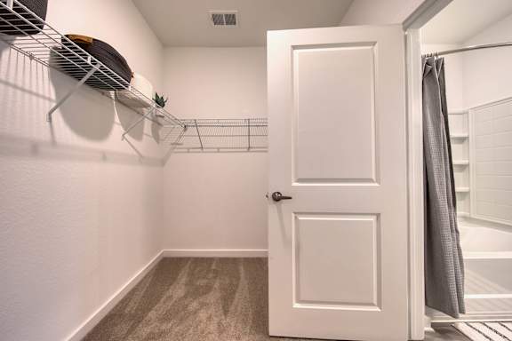 A white door is open to a bathroom.