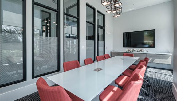 a conference room with a long white table and red chairsat Altis Grand Lake Willis, Florida