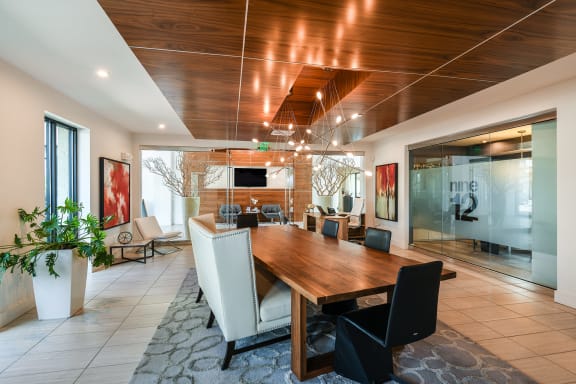 a dining room with a wooden table and chairs