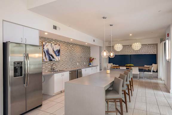 A modern kitchen with a large island and stainless steel appliances.