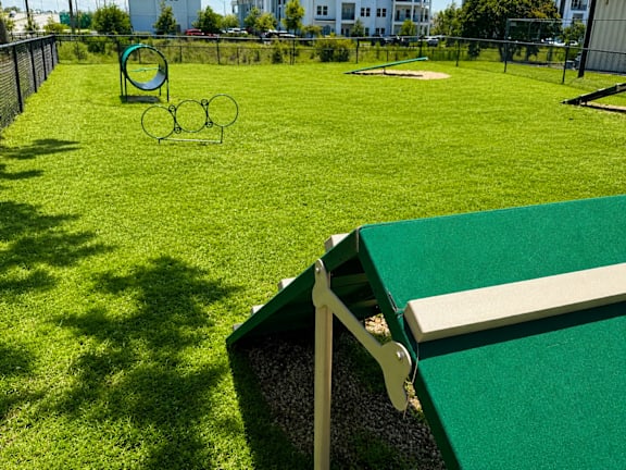 A playground with a green slide and a green and white slide.