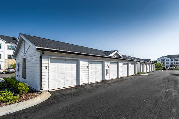 A row of white garage doors are closed.
