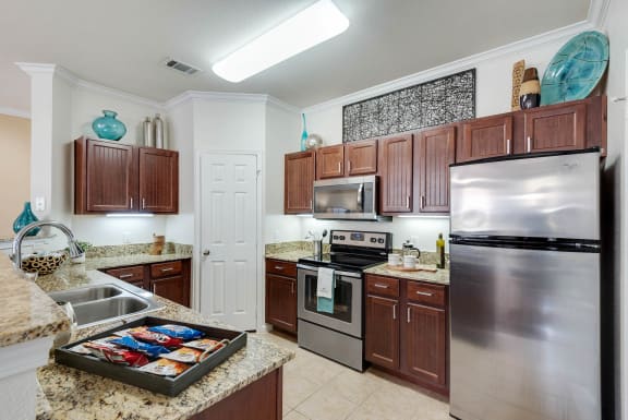 a kitchen with stainless steel appliances and granite counter tops