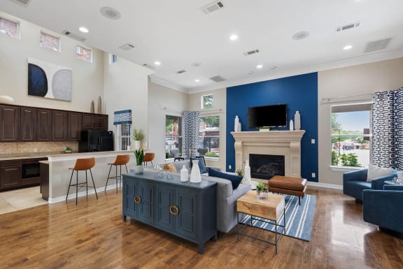 a living room with a blue accent wall and a fireplace at Orion McKinney, McKinney, TX, 75070