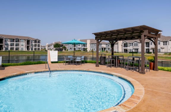 a swimming pool with a gazebo next to a resort style pool  at Orion Prosper, Prosper