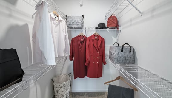 a walk in closet filled with clothes and bags at Altis Grand Lake Willis, Orlando, FL 32821