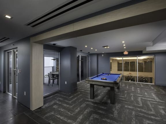 a spacious game room with a pool table and a bar at Saba Pompano Beach, Florida