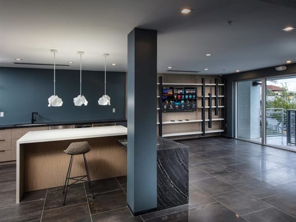 a kitchen with a large island with a white countertop at Saba Pompano Beach, Florida, 33062