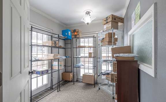 A room with a lot of boxes on shelves and the floor at Winchell Way Apartment , Kalamazoo, Michigan
