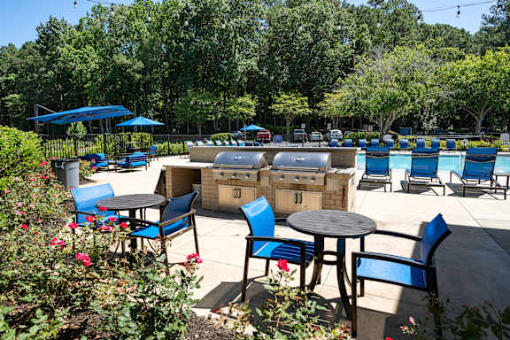 A sunny day at the outdoor seating area with blue chairs and tables.