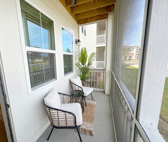 A balcony with a chair and table.