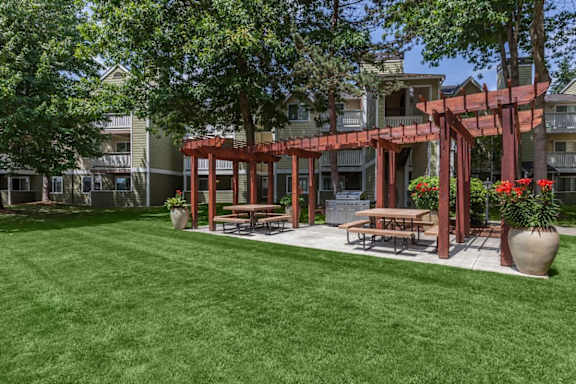 An outdoor area with a grill and tables.