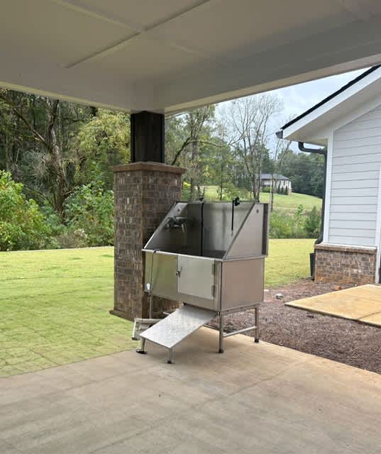 A large outdoor grill is on a patio.
