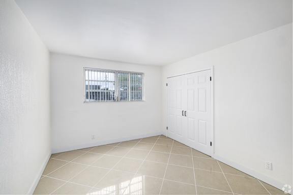 A white room with a window and a door.