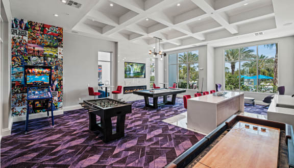 a game room with a pool table and ping pong at Altis Grand Lake Willis, Florida, 32821