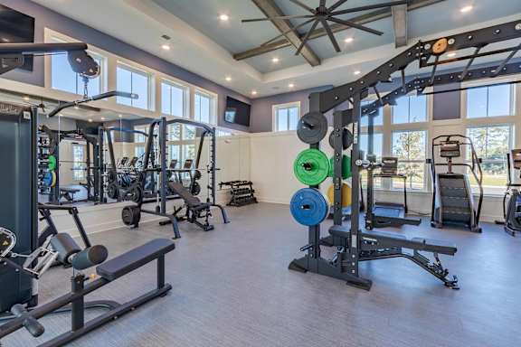A spacious home gym with a variety of exercise equipment.