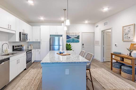 A kitchen with a blue island in the middle.