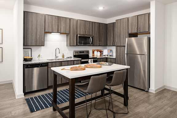 A modern kitchen with a table and chairs.