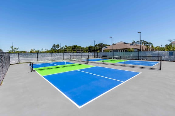 A tennis court with blue and green colors.