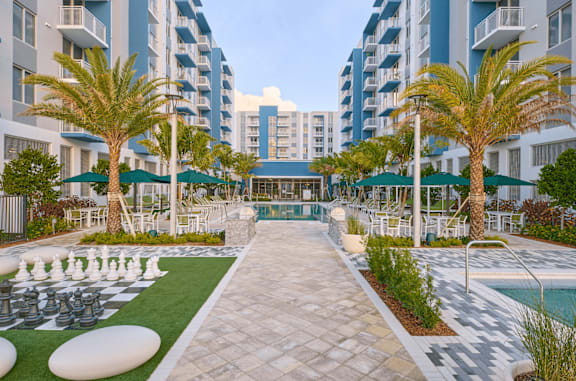 A pool area with a chess board in the middle.