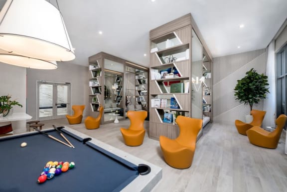 a games room with a pool table and chairs at Regatta at New River, Fort Lauderdale Florida