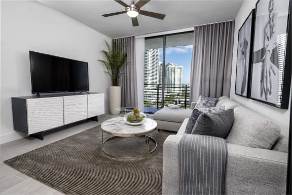 a living room filled with furniture and a flat screen tv at Regatta at New River, Fort Lauderdale, 33301