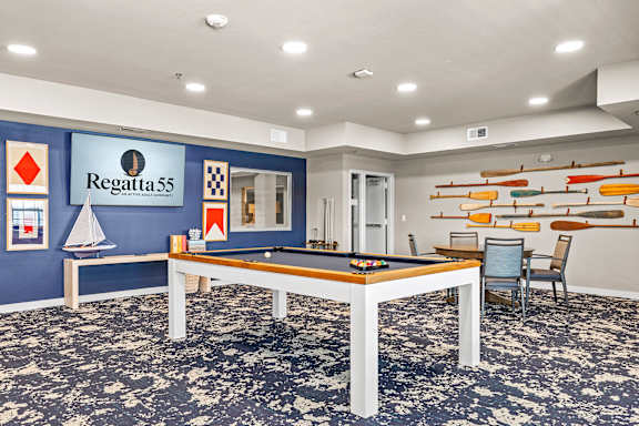 A room with a pool table and a sign that says Regatta 55.