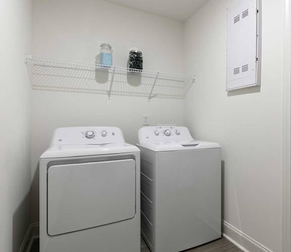 A small laundry room with a washer and dryer.