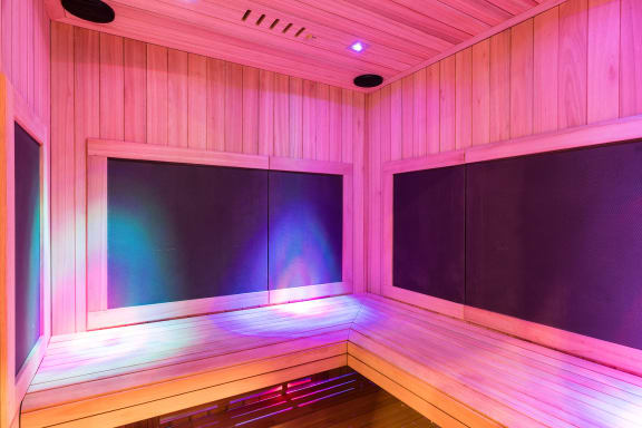 a room with wood paneling and colourful lights