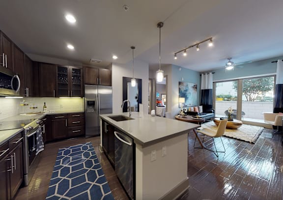 A modern kitchen with dark wood cabinets and a white island.