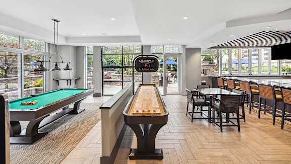 A room with a pool table and a sign that says "Champions".
