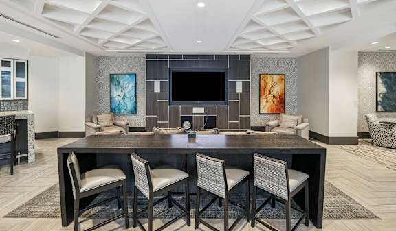 A modern dining room with a large table and chairs.