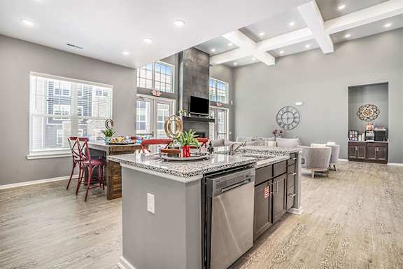 A kitchen with a large island and stainless steel appliances.
