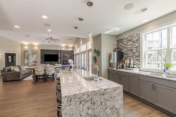 A kitchen with a marble island in the middle of the room.