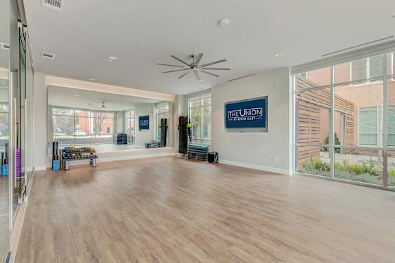A spacious room with a ceiling fan and a sign that reads "The Union.".