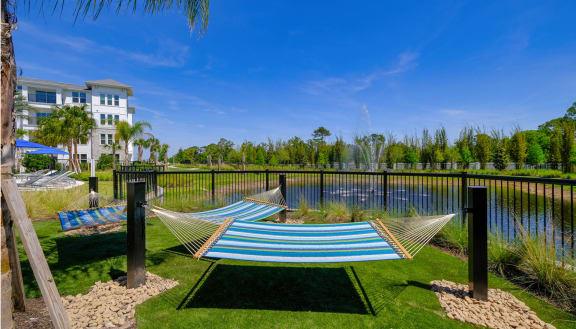 two hammocks overlooking the water at the preserve at polk apartments at Altis Grand Lake Willis, Orlando, 32821