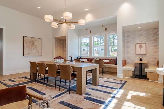 A dining room with a table and chairs.