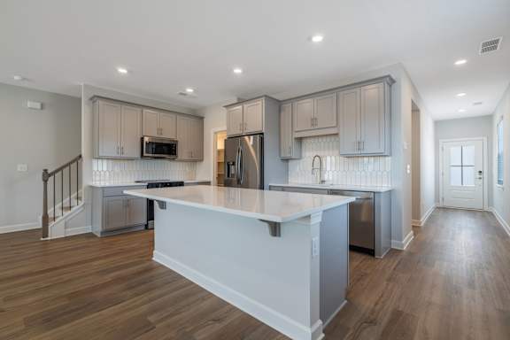 A modern kitchen with a large island in the middle.
