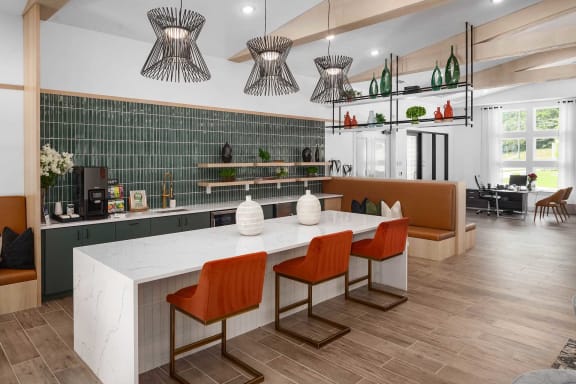 a large kitchen with a white counter and chairs